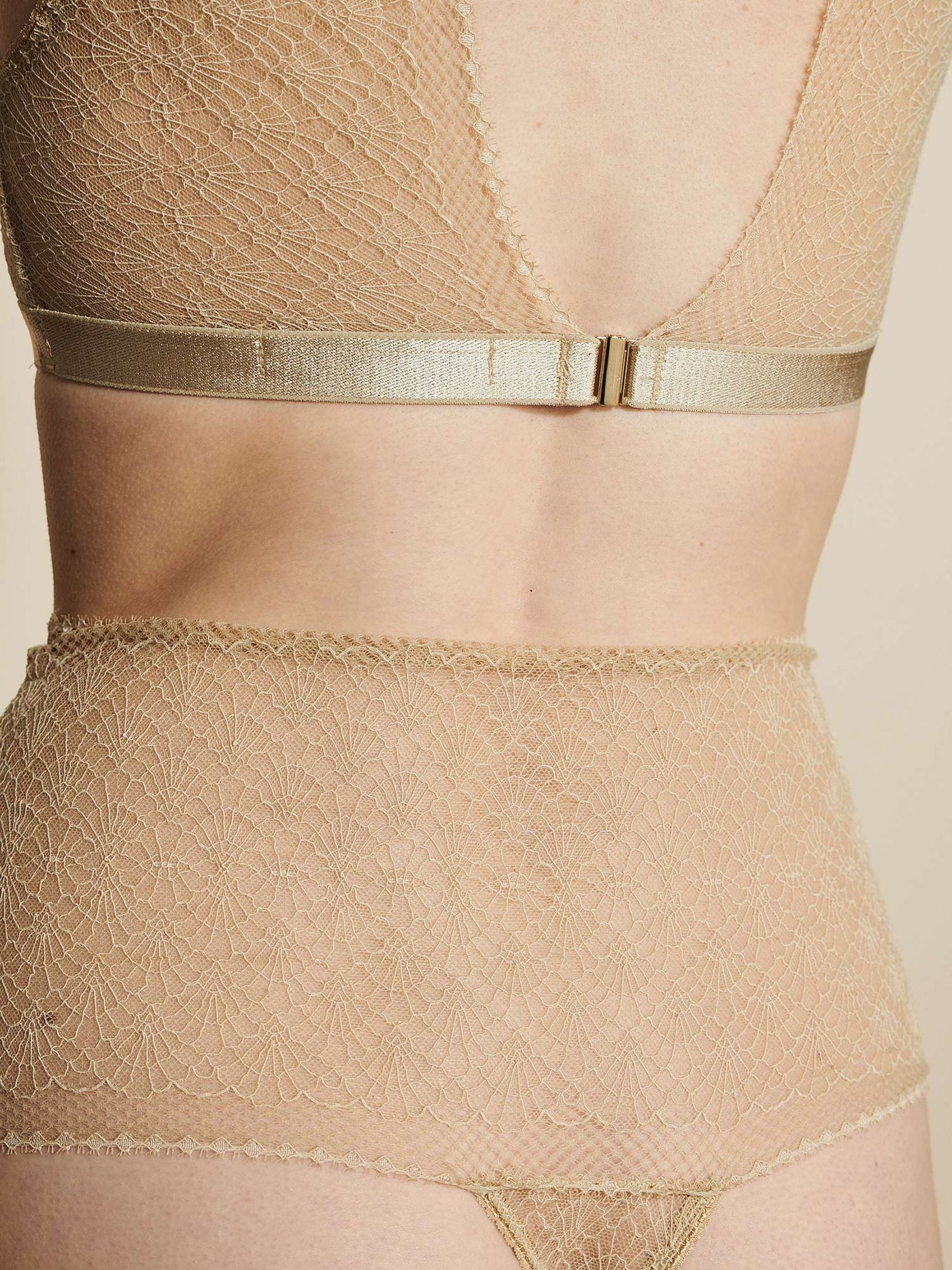 Female wearing our Christy High String Beige. Seen from the back and in a close up.